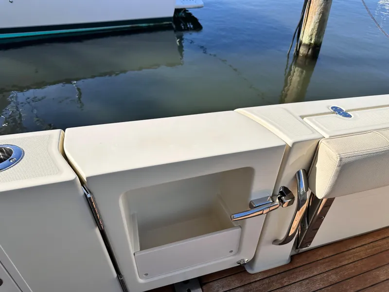 Slide: The Image of 2021 Chris-Craft Calypso 35 boat deck with storage compartment and water view. - 15