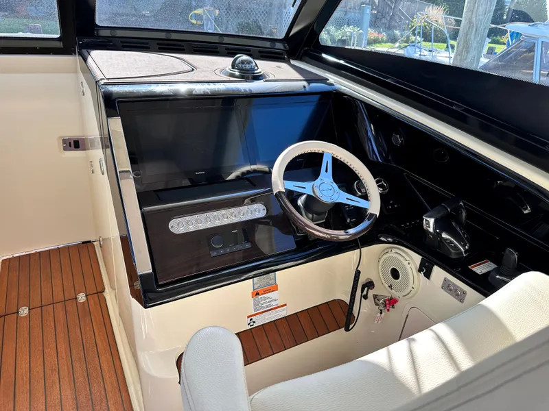 Slide: The Image of 2021 Chris-Craft Calypso 35 helm with wooden flooring and modern steering wheel. - 16