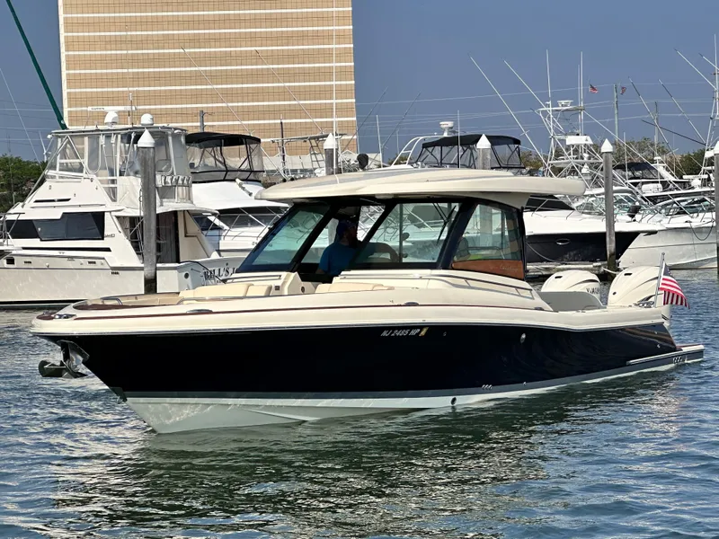 Slide: The Image of 2021 Chris-Craft Calypso 35 boat docked in a marina. - 2