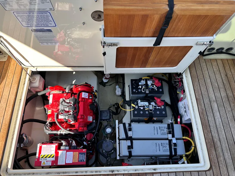 Slide: The Image of Engine compartment of a 2021 Chris-Craft Calypso 35 boat with visible batteries and wiring. - 21