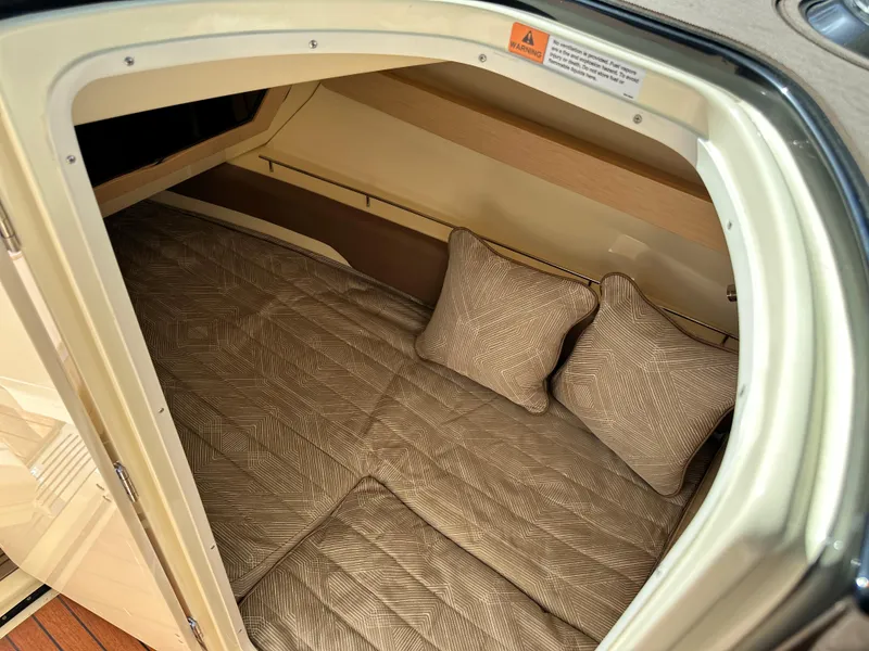 Slide: The Image of 2021 Chris-Craft Calypso 35 cabin interior with cozy bedding and pillows. - 27