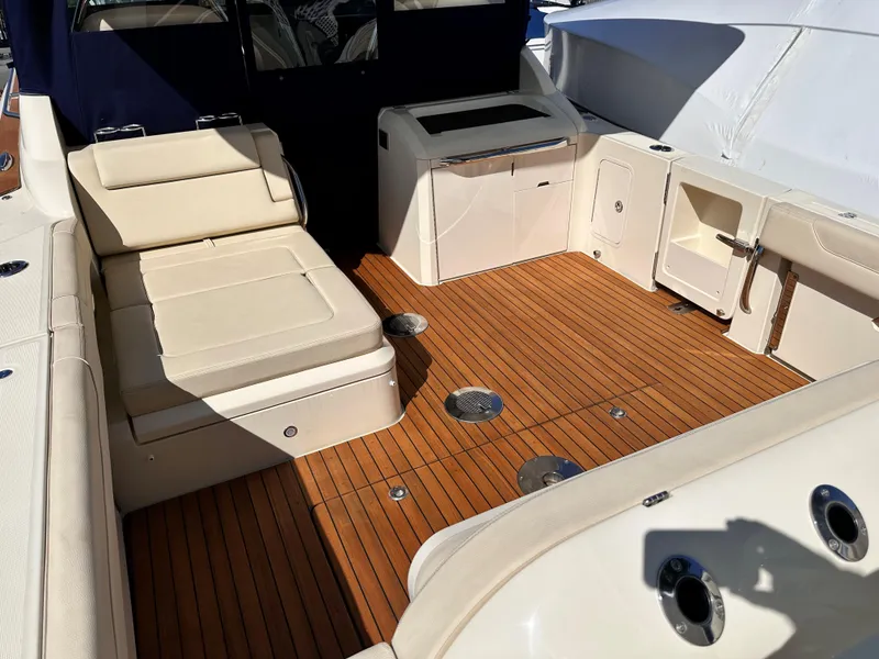 Slide: The Image of 2021 Chris-Craft Calypso 35 boat interior with teak flooring and beige seating. - 31