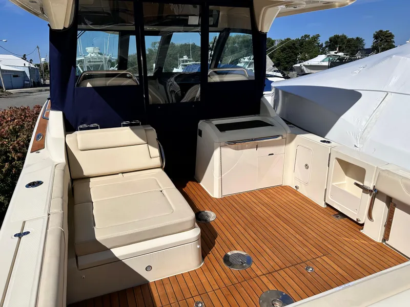 Slide: The Image of 2021 Chris-Craft Calypso 35 boat interior with teak flooring and beige seating. - 32