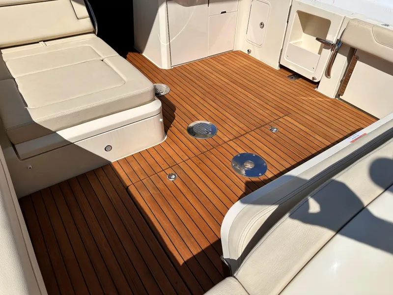 Slide: The Image of 2021 Chris-Craft Calypso 35 boat interior with teak flooring and beige seating. - 33