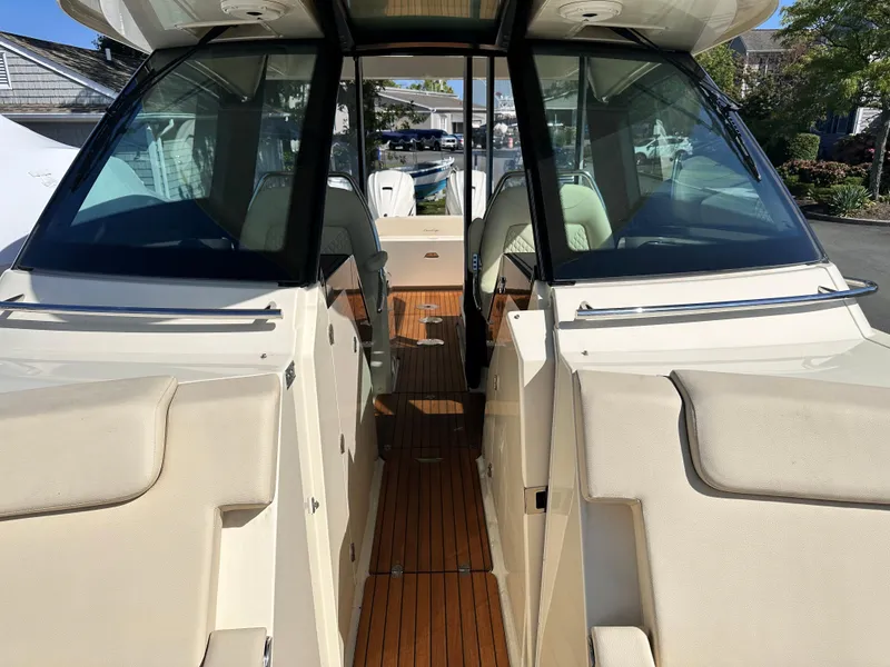 Slide: The Image of 2021 Chris-Craft Calypso 35 boat interior with teak flooring and cushioned seating. - 38