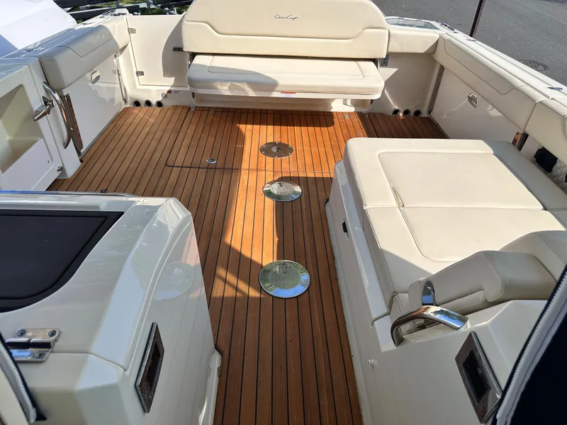 Slide: The Image of 2021 Chris-Craft Calypso 35 boat interior with teak flooring and white seating. - 39