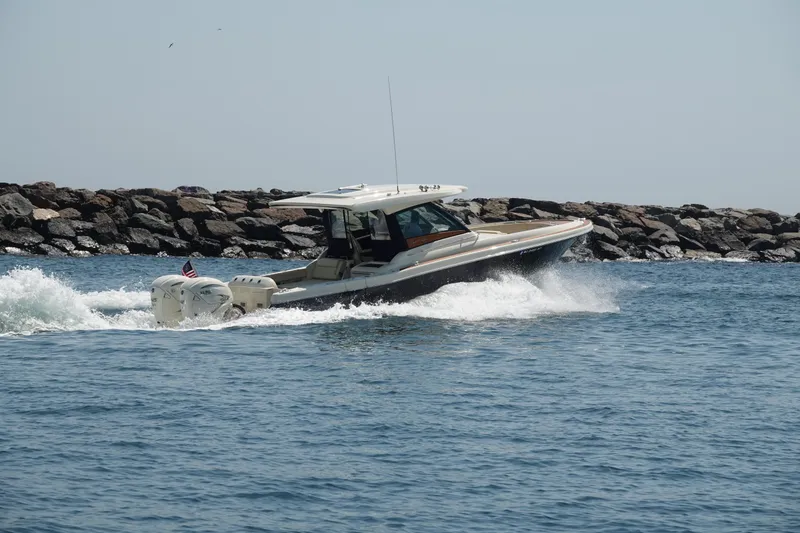 Slide: The Image of 2021 Chris-Craft Calypso 35 boat cruising near rocky shoreline. - 4
