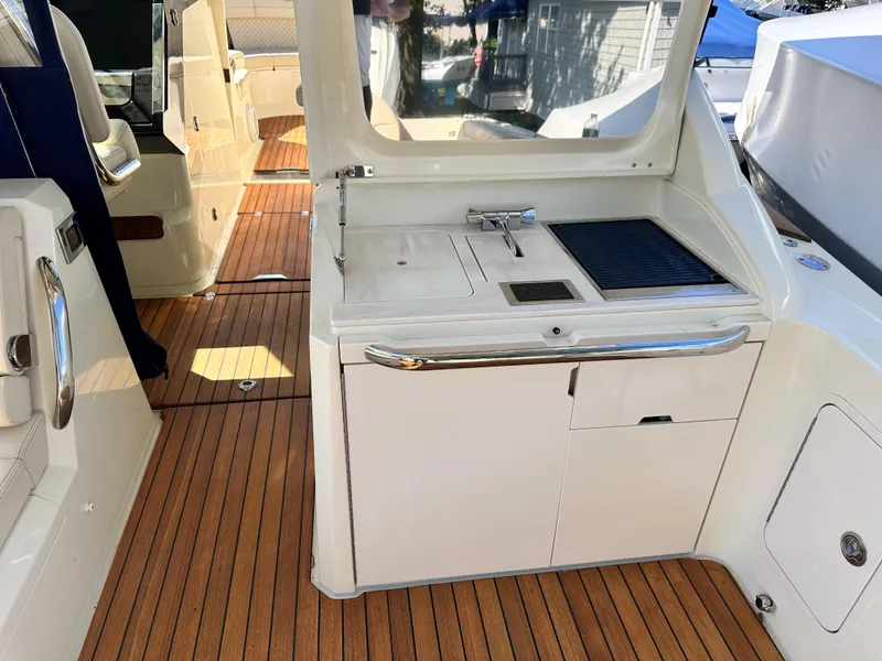 Slide: The Image of 2021 Chris-Craft Calypso 35 boat interior with teak flooring and kitchenette. - 43