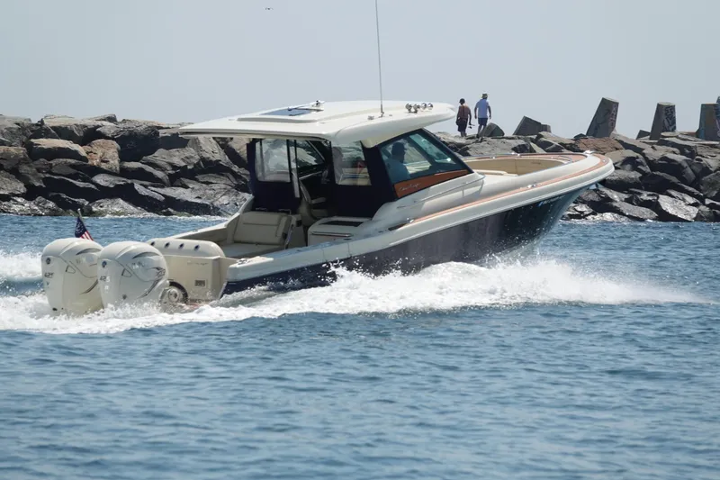 Slide: The Image of 2021 Chris-Craft Calypso 35 boat cruising near rocky shoreline. - 5