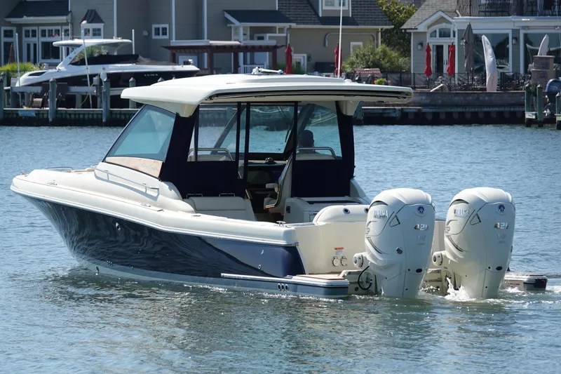 Slide: The Image of 2021 Chris-Craft Calypso 35 boat with twin outboard engines on the water. - 9