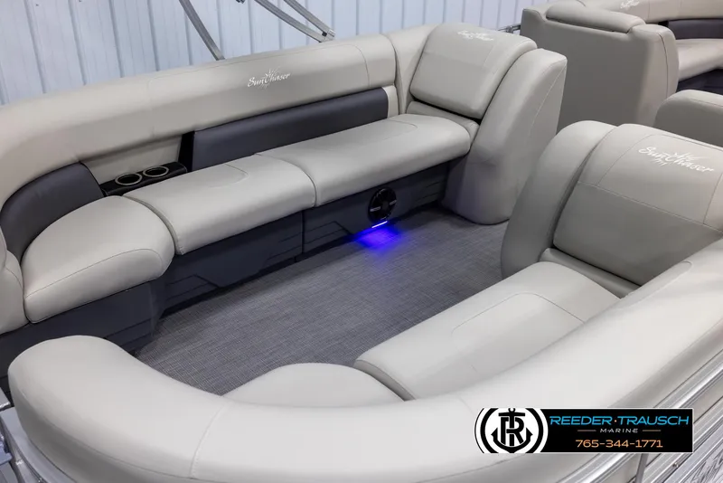 Slide: The Image of 2024 SunChaser Vista 22 LR pontoon boat interior with plush seating and blue LED lighting. - 12