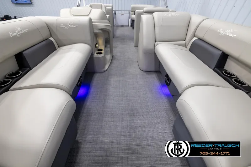 Slide: The Image of 2024 SunChaser Vista 22 LR pontoon boat interior with plush seating and blue LED lighting. - 13
