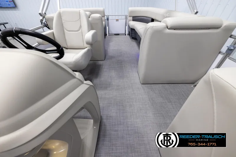 Slide: The Image of 2024 SunChaser Vista 22 LR pontoon boat interior with plush seating and steering console. - 14
