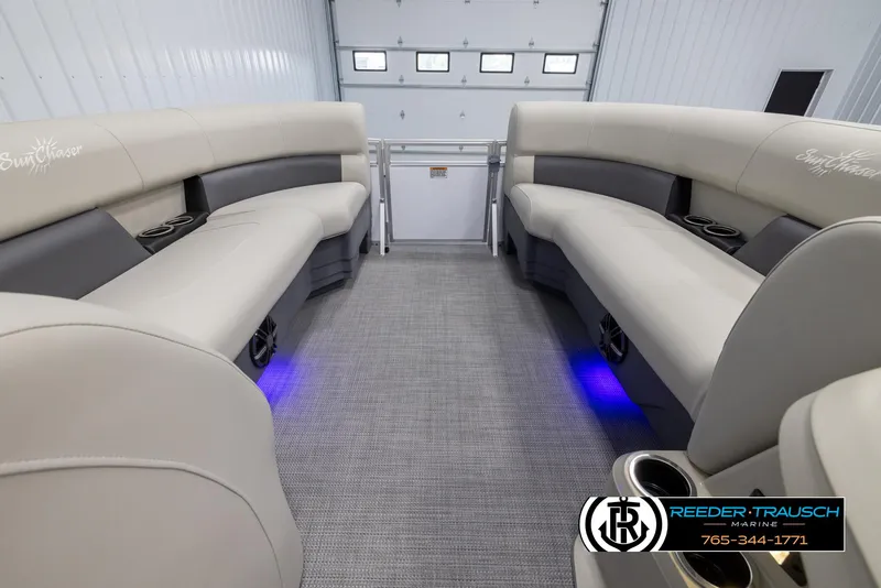 Slide: The Image of 2024 SunChaser Vista 22 LR pontoon boat interior with beige seating and blue LED lighting. - 18