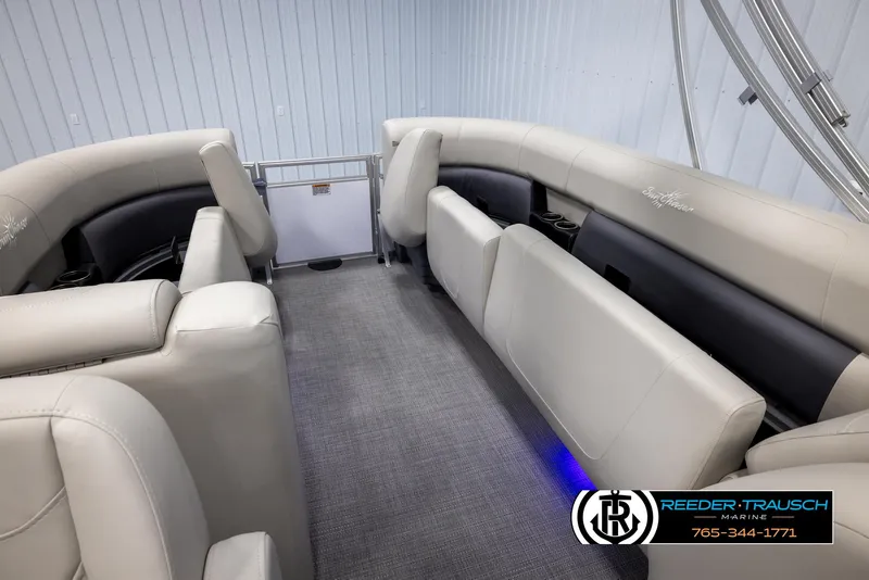 Slide: The Image of 2024 SunChaser Vista 22 LR pontoon boat interior with plush seating and carpeted floor. - 23