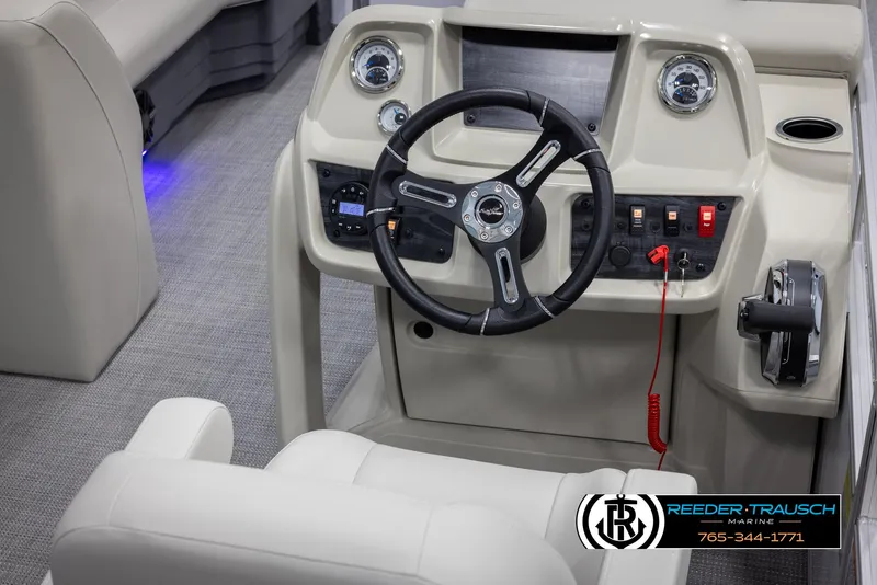 Slide: The Image of 2024 SunChaser Vista 22 LR boat dashboard with steering wheel and control panel. - 24
