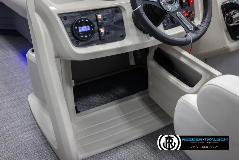 Slide: The Image of 2024 SunChaser Vista 22 LR boat dashboard and steering wheel with storage compartments. - 38