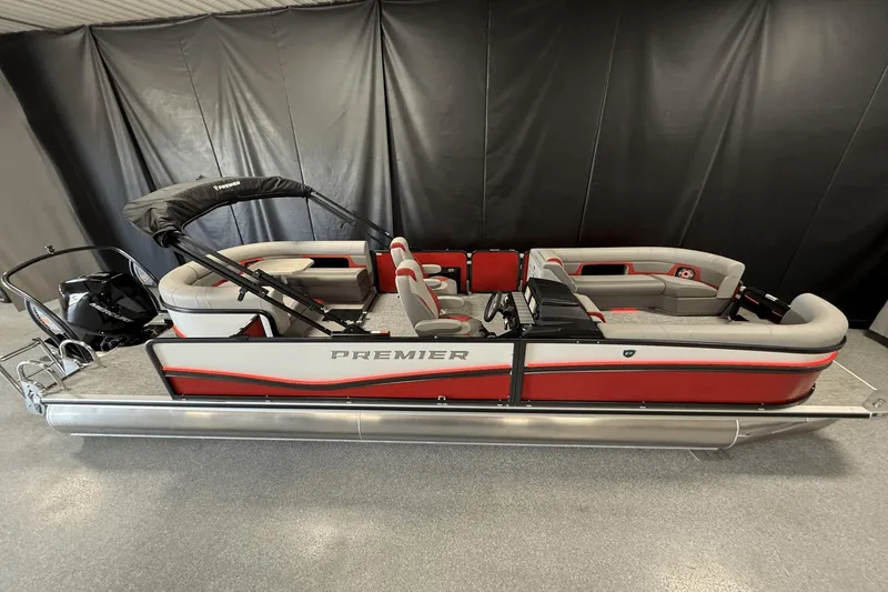 Slide: The Image of 2024 Premier 250 Solaris pontoon boat with red and gray seating, displayed indoors. - 1