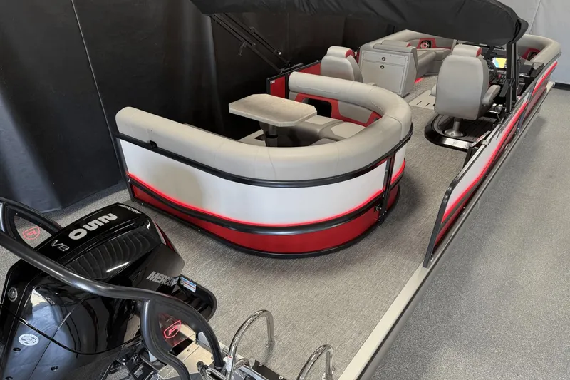 Slide: The Image of 2024 Premier 250 Solaris pontoon boat interior with seating and Mercury engine. - 11