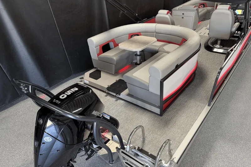 Slide: The Image of 2024 Premier 250 Solaris pontoon boat interior with seating and motor. - 12