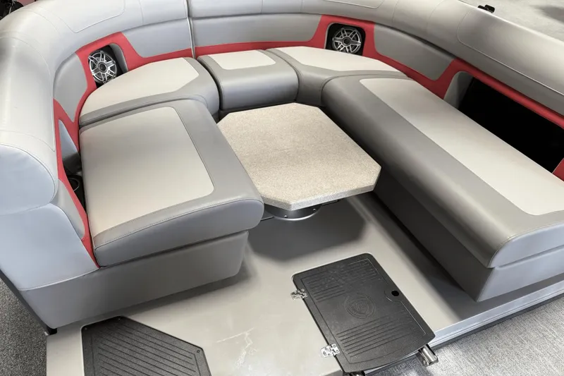 Slide: The Image of 2024 Premier 250 Solaris boat interior with gray and red seating, featuring a central table. - 15