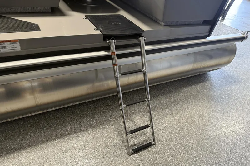 Slide: The Image of 2024 Premier 250 Solaris pontoon boat with a foldable ladder on a metallic surface. - 18