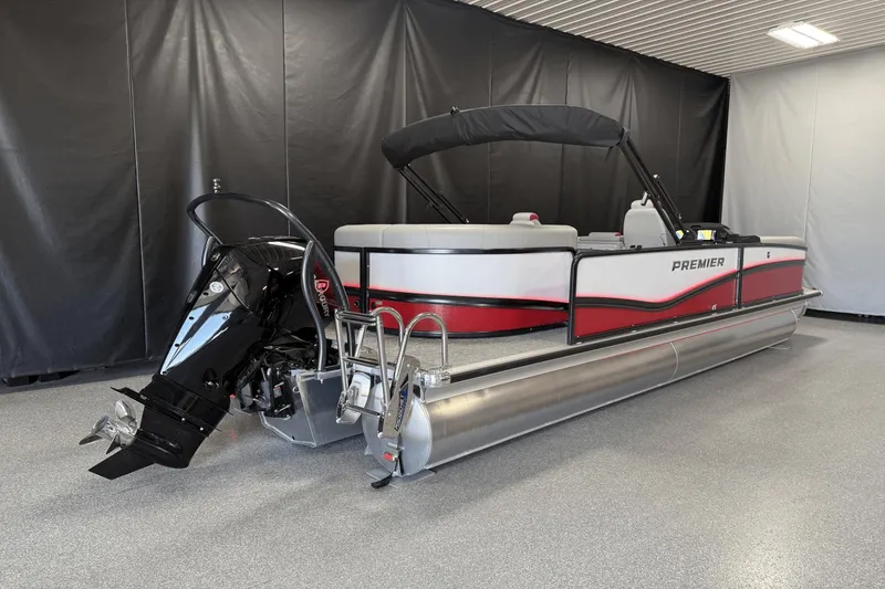 Slide: The Image of 2024 Premier 250 Solaris pontoon boat in showroom, featuring sleek design and modern outboard motor. - 2