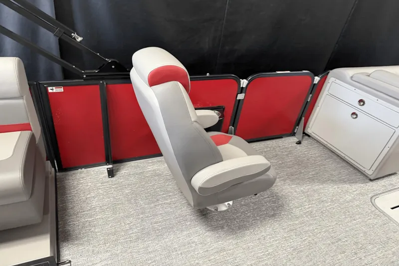 Slide: The Image of 2024 Premier 250 Solaris boat interior with red and gray seating and storage. - 24
