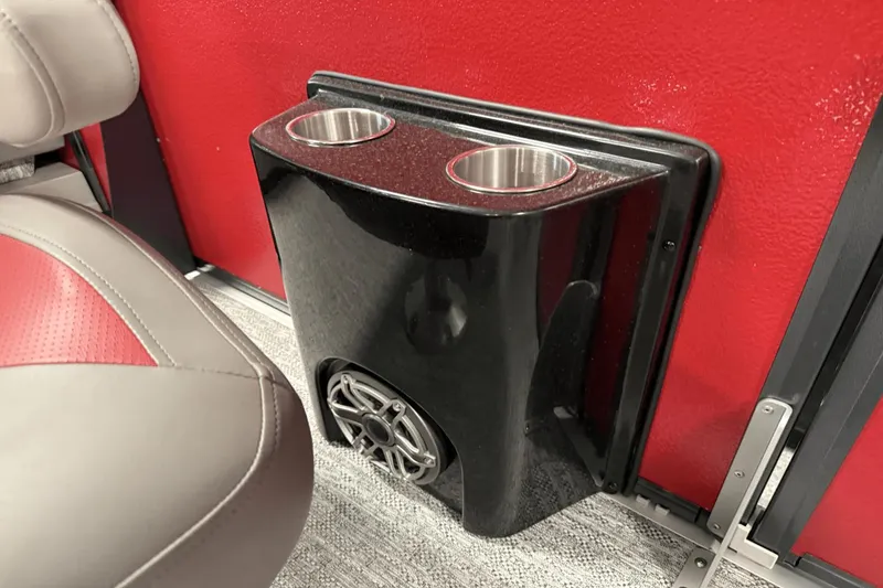 Slide: The Image of 2024 Premier 250 Solaris interior with cup holders and speaker on red panel. - 26