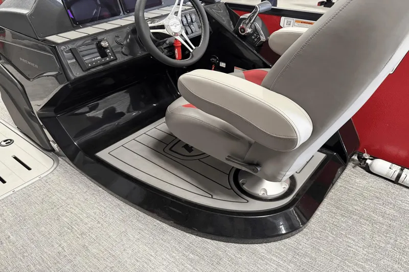 Slide: The Image of 2024 Premier 250 Solaris boat helm with steering wheel and captain's chair. - 28
