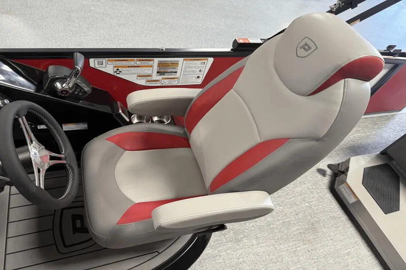 Slide: The Image of Captain's chair in 2024 Premier 250 Solaris boat, featuring red and gray upholstery. - 31