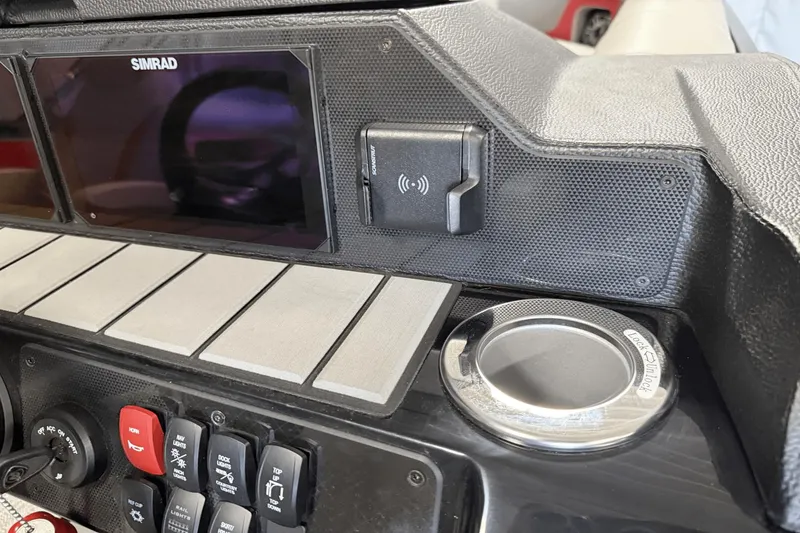 Slide: The Image of 2024 Premier 250 Solaris dashboard with Simrad display and control switches. - 36