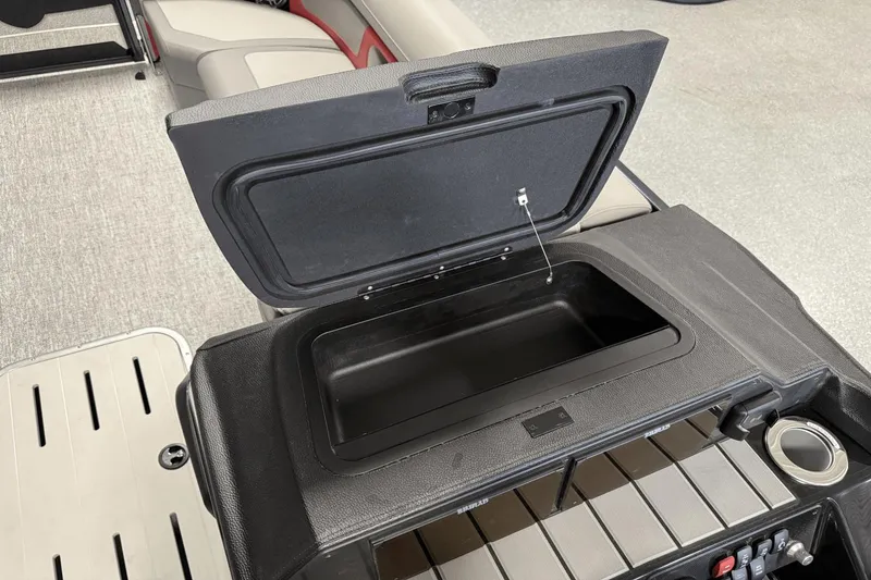 Slide: The Image of Open storage compartment on 2024 Premier 250 Solaris boat with seating and controls. - 38