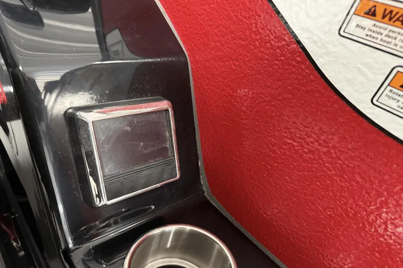 Slide: The Image of Close-up of 2024 Premier 250 Solaris boat dashboard with warning labels and metallic accents. - 40