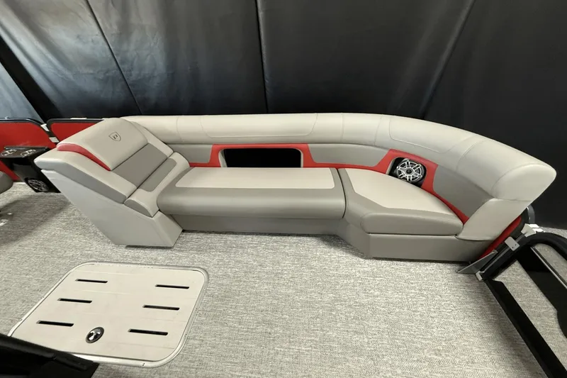 Slide: The Image of 2024 Premier 250 Solaris boat interior with gray and red seating, featuring a built-in speaker. - 45