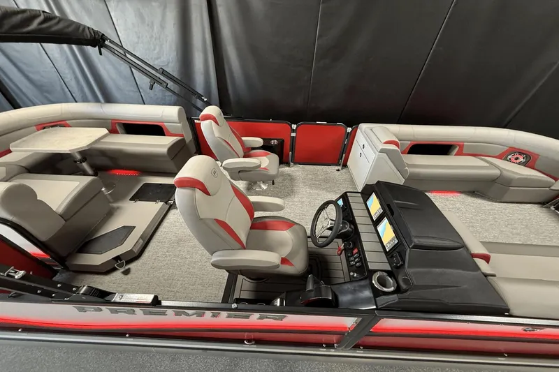 Slide: The Image of 2024 Premier 250 Solaris pontoon boat interior with plush seating and modern dashboard. - 5