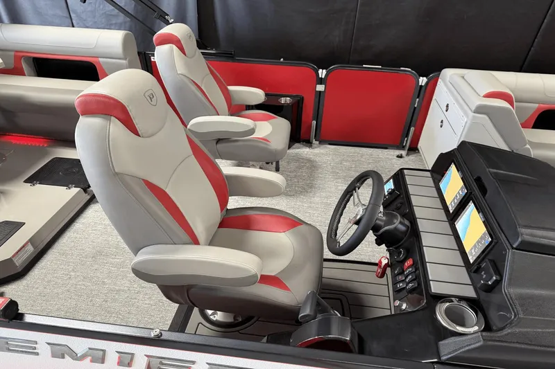 Slide: The Image of 2024 Premier 250 Solaris boat interior with red and gray seating, dual screens, and steering wheel. - 7