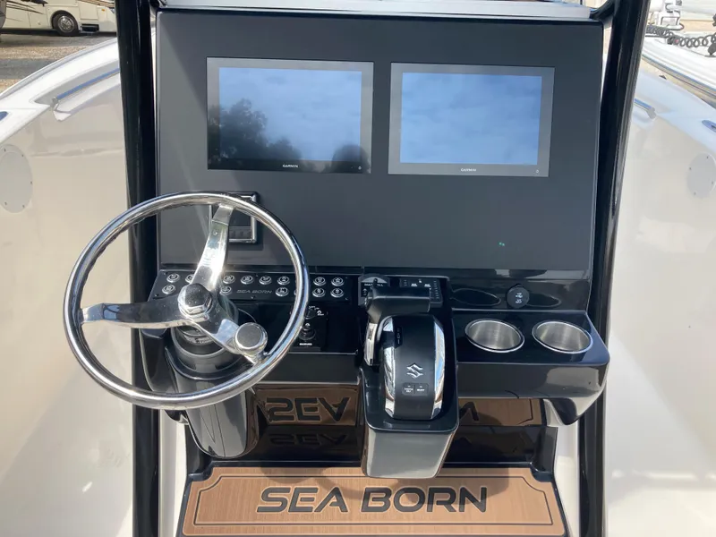 Slide: The Image of 2024 Sea Born SX239 Offshore boat dashboard with dual screens and steering wheel. - 10