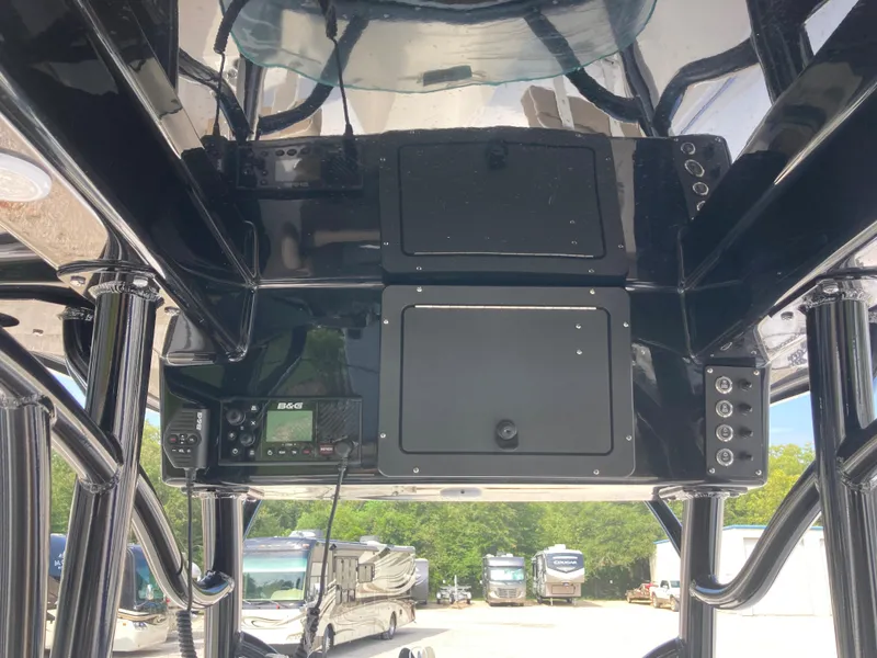 Slide: The Image of 2024 Sea Born SX239 Offshore boat console with electronic controls and storage compartments. - 11