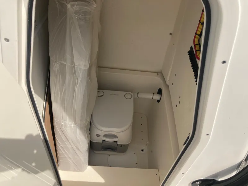 Slide: The Image of 2024 Sea Born SX239 Offshore boat interior with compact toilet. - 7