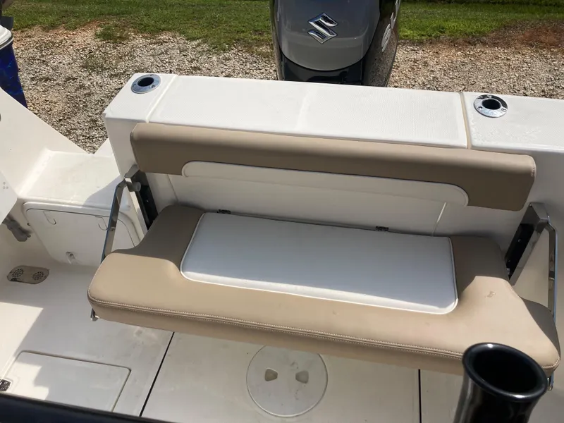 Slide: The Image of 2024 Sea Born SX239 Offshore boat with beige seating and Suzuki outboard motor. - 9