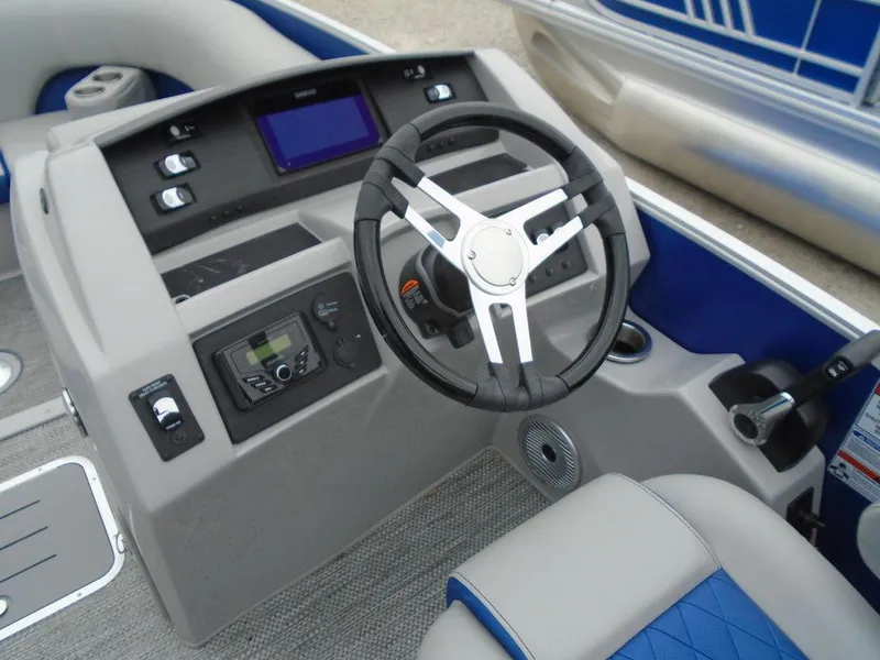 Slide: The Image of 2024 Bennington 23 LTFB boat dashboard with steering wheel and control panel. - 14