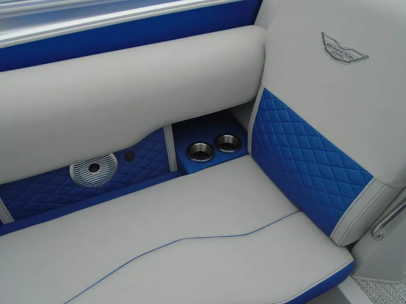 Slide: The Image of 2024 Bennington 23 LTFB boat interior with blue and gray seating, cup holders, and speaker. - 18
