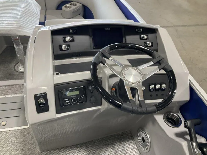 Slide: The Image of 2024 Bennington 23 LTFB boat dashboard with steering wheel and control panel. - 5