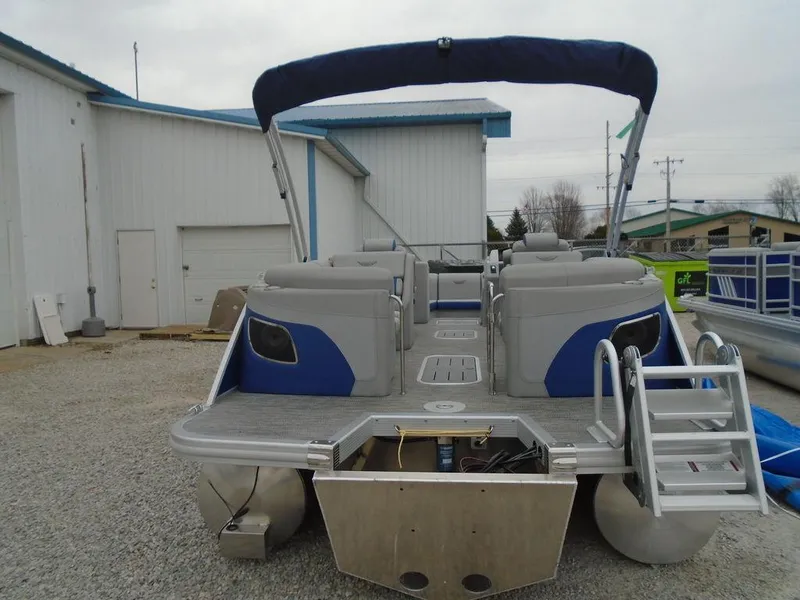Slide: The Image of 2024 Bennington 23 LTFB pontoon boat with blue canopy and rear entry ladder. - 9