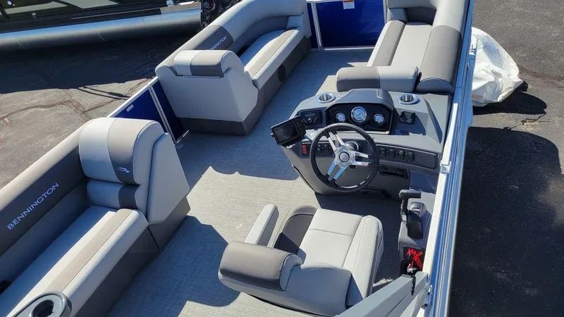 Slide: The Image of 2023 Bennington 20 SVL pontoon boat interior with plush seating and modern dashboard. - 3
