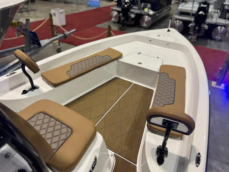 Slide: The Image of 2024 Clearwater 2100 Baystar boat interior with cushioned seating and diamond-patterned flooring. - 10