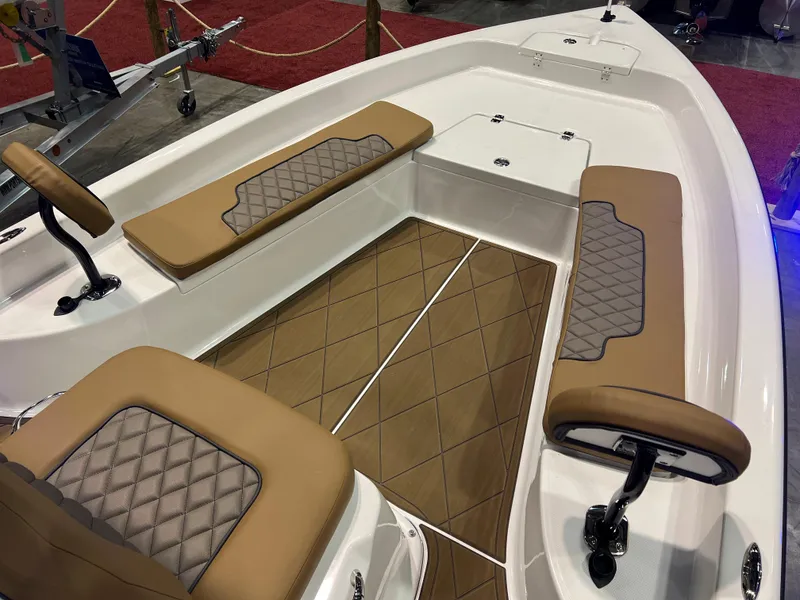 Slide: The Image of 2024 Clearwater 2100 Baystar boat interior with tan and gray cushioned seating. - 13