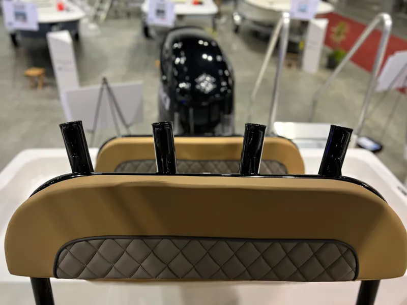 Slide: The Image of 2024 Clearwater 2100 Baystar boat interior with rod holders and engine in background. - 14