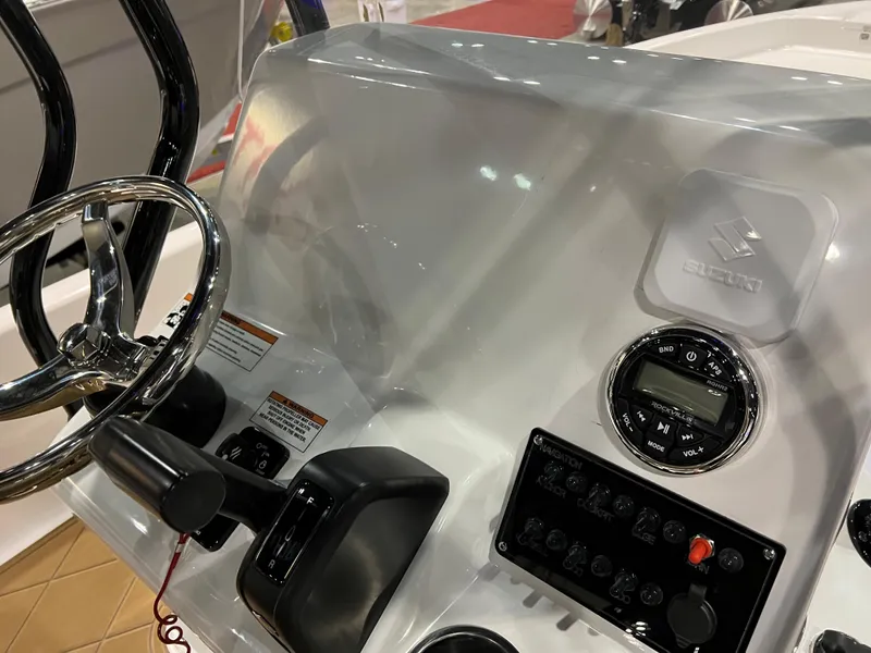 Slide: The Image of 2024 Clearwater 2100 Baystar boat dashboard with steering wheel and control panel. - 16